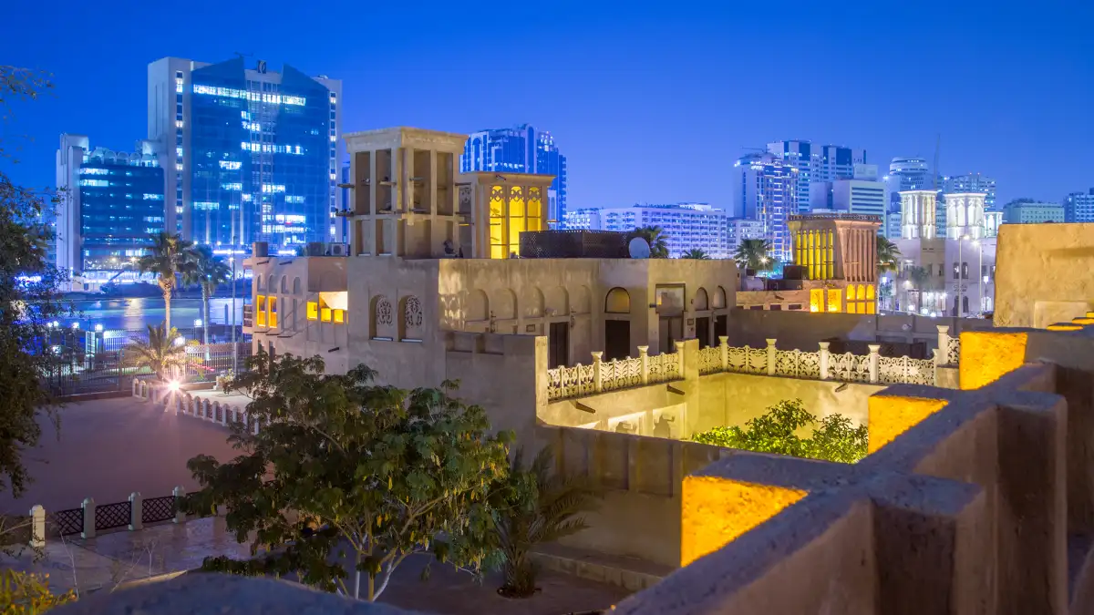 Courtyard and alleys of historic Al Fahidi neighborhood with traditional wind towers in afternoon light