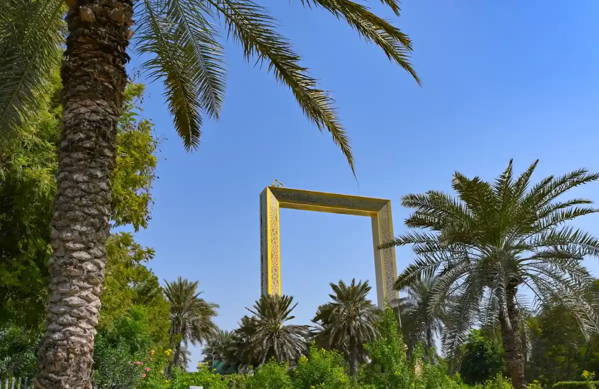 Dubai Frame in Zabeel Park among palm trees and blue sky